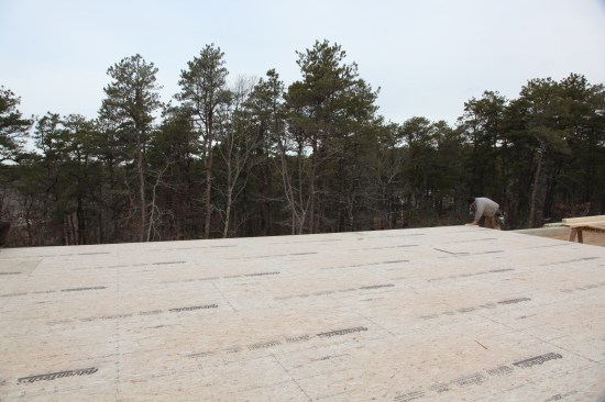 Here, a crew member measures the exact length of the baseline wall.