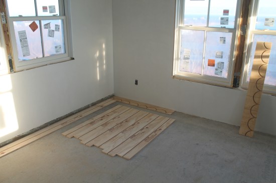 After the reference lines are snapped, single panels are installed along one wall as a guide. Special return panels line up with grooves in the straight panels.