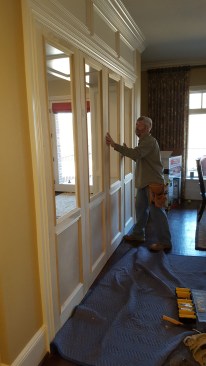 After scribing and mounting the operable panels, the author aligns their free edges by pushing lightly  at the bottom of the stationary panel.