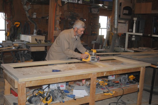 After the glue sets and clamps are removed, the author uses a router with a flush-trim bit to true up the surfaces.