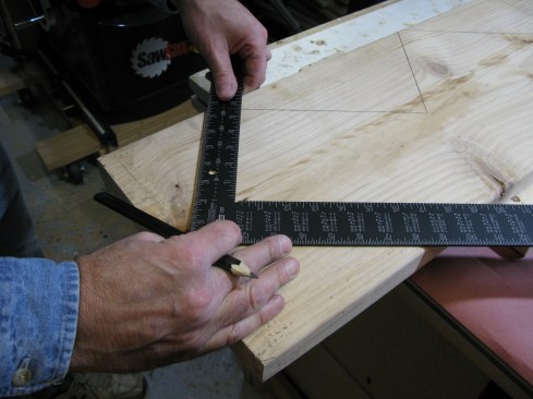 With the tongue of the square on the perpendicular line, align the blade with the rise measurement and draw the line for the bottom of the stairs. Repeat the same procedure to draw in the top of the stairs.