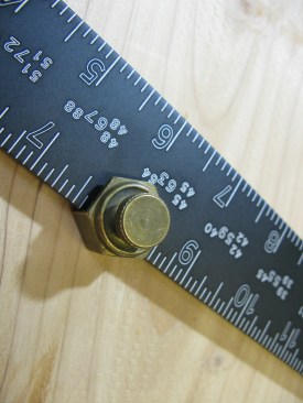 Working out from the heel, or point, of the square, attach the first stair gauge at the rise measurement on the tongue of the framing square (the narrow portion).