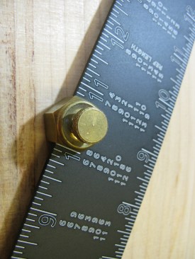 Measure out from the heel of the square and attach the second stair gauge on the blade (wider portion) of the framing square at the run measurement.