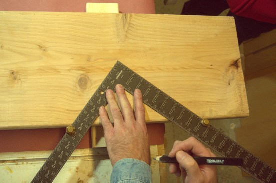 Slide the square against the edge of the board until the gauges make contact. Start with the run gauge 4 or 5 inches from the end of the board.