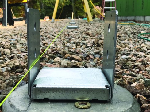 The crew checked the alignment of  the footings at every step, and a taut  string confirmed that both the height  and the placement of all 11 footings along the 78-foot length of the porch  were within 1/8 inch.