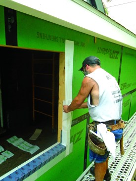 The top piece of flashing starts a few inches above the opening and laps over the piece below.