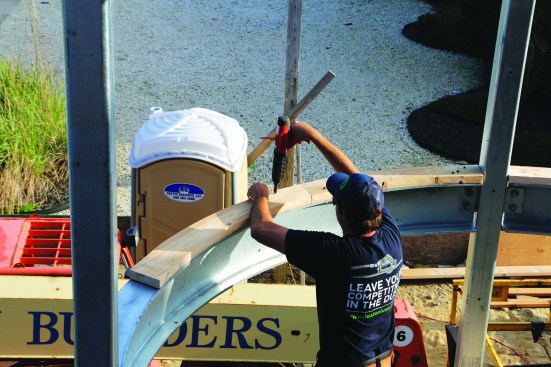 The curved plates were tacked in place with powder-actuated fasteners (12), then through-bolted to the top flange of the steel beam.