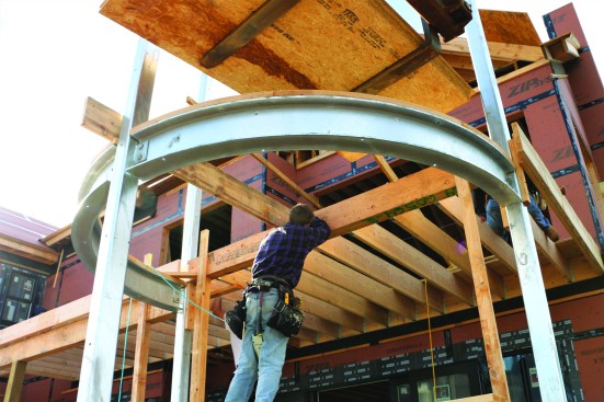 The flush beam was braced between the columns for framing the deck. Later, the hangers were welded to the columns.