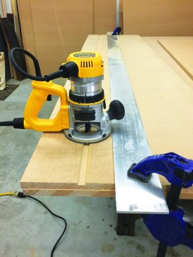 He used the same straightedge as a router guide for the long dado cuts.