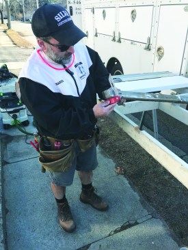 The original sill was cut and installed at an angle (about 13 degrees) to shed water readily. The author records the plumb angle from the front of the sill with a bevel gauge.