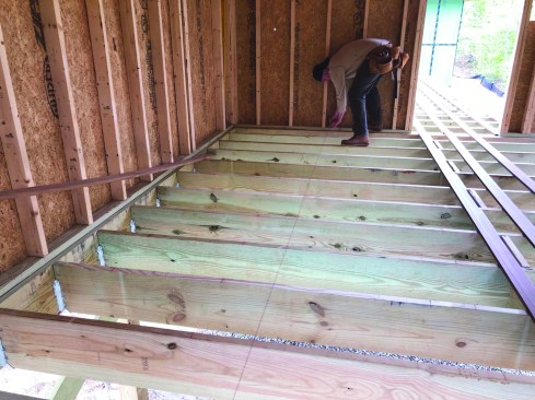 For areas where the decking is continuous from one area into another, the crew lays out every third board in one area, and then projects that layout into the adjacent area.