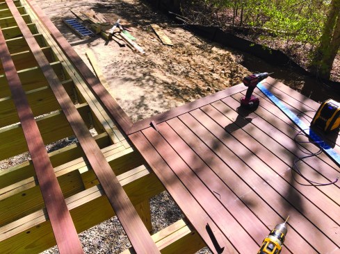 For L-shaped decks, the layout starts from the corner where the two sections meet, and extends in both directions from that point.