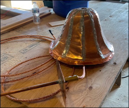 The bell-shaped finial (formed over a molded solid piece of PT wood), lightning rod, and braided copper wire prior to installation.