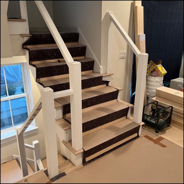 Existing newels were basic 4x4 painted poplar, left in place as the new posts’ structural core.