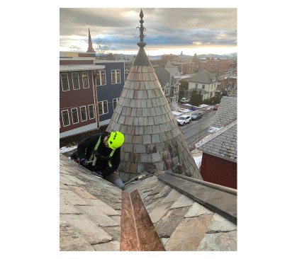 Ryan Catania of Stewardship Slate finishes up restoring a 120-year-old slate roof in Burlington, Vermont. Photo by Michael Dillon
