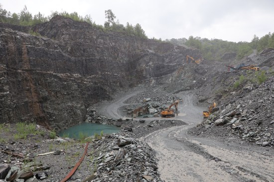 Large pieces of slate or “blocks” are transported from the pit to a nearby processing mill via a big-haul truck or smaller dump trucks. Water, seen here on the right, needs to be pumped out of the pit every day.