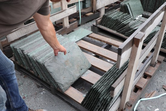 The holing process for thicker material, such this ¾-inch-thick piece of unfading mottled green and purple slate, is done with a hammer-drill with a long masonry bit.