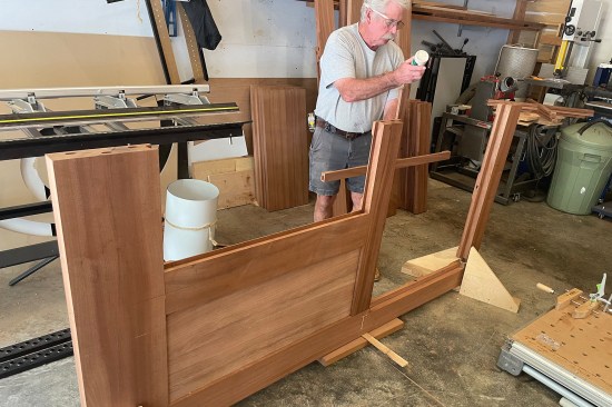 The bottom and middle rails are tenoned to the center stile, which locks in the first door panel. The author begins gluing up and tenoning the muntin “cross”—the muntins were joined with a half-lap joint.