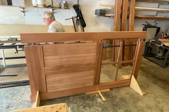 The last stile is in the process of being driven down tight. (The author uses a 3-pound sledgehammer and a wood block to drive the pieces together).