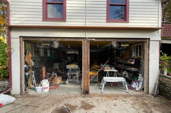 The existing garage doors and framework were removed, which exposed rotted jamb and center support framing.