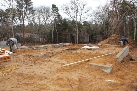 With the corners of the garage marked out, we pulled diagonal measurements to ensure the layout was perfectly square.