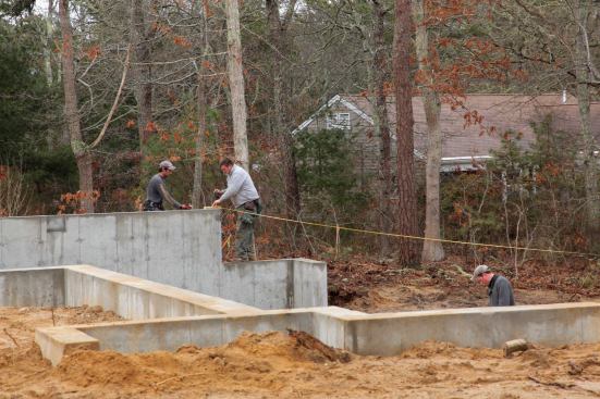 Then it was simply a matter of one crew member holding the tape on the mudsill, while a second person marked the measurement on the foundation at both ends of each wall.