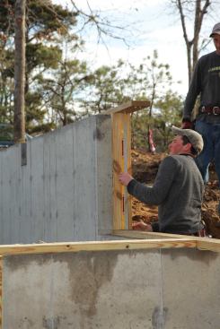 We run continuous sill everywhere the framing will touch the concrete foundation, including on vertical walls where the foundation steps down.