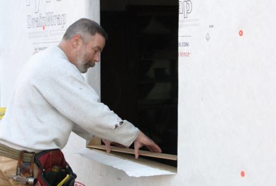Slope the Sill
I fasten a piece of beveled siding to the rough sill, with the thick edge toward the interior, to direct moisture outside.