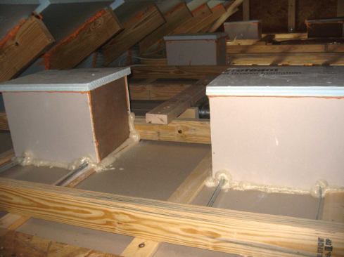 Recessed lights in an unconditioned attic can be sealed at any time before insulation with site-made boxes.