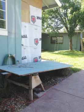 A layer of housewrap was stapled to the studs.