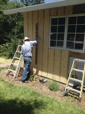 On these installs, the first sheet is checked for plumb, then it and the next sheet or two are tacked into place so they can be adjusted if the panels start to run out of line.