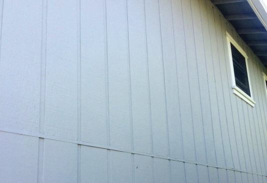 On the part of the house with two stories, the bottom sheets were installed first, topped with metal Z-flashing. The top sheets rested on the flashing.