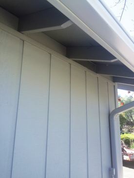 Because rafters and eaves blocking never line up perfectly, the author purposely leaves a 1/4-inch gap at the top of the panels, which he caulks and finishes with 1x3 trim.
