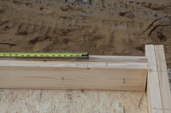 For walls that attach inside other walls, stud layout is a little different. Layout for the first stud is marked by holding the 5 1/2 inch mark on the end of the plates. A nail is then driven at the layout mark and the tape is hooked on the nail.