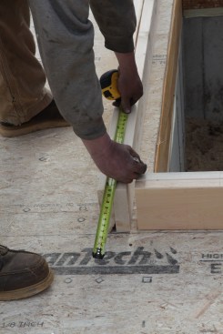 When a wall is interrupted by a jog, first measure the distance to the end of the first wall. Set the tape at that measurement to begin the layout on the second wall.