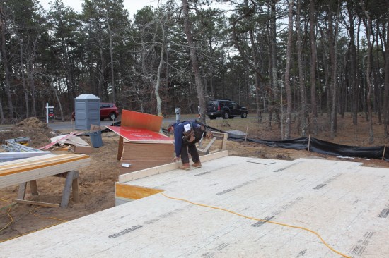 After the boards are tacked together, the pair is set in place on the perimeter of the deck where the wall will be built.