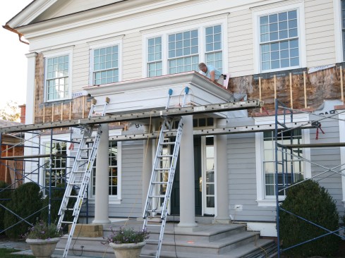 The project’s GC built the new entry over an existing flight of stone entry steps, which helped dictate the overall roof size of 12 feet wide by 9 feet deep. The GC’s crew built the plywood deck with a slightly pitched hip roof (for drainage and to keep the crown molding at the same level), and then waterproofed the roof deck with Grace Ice and Water Shield. When we arrived on site to take measurements—before fabricating the roof’s components back at our shop—the portico was pretty much done.