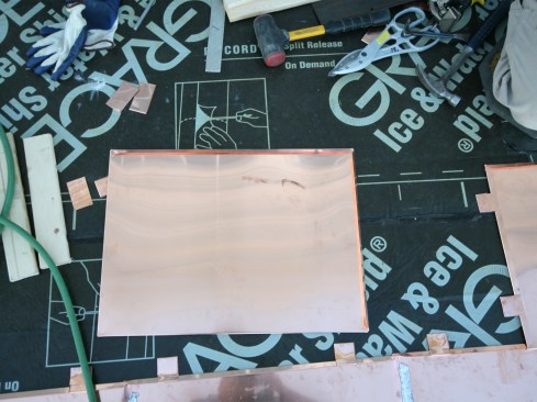 On this job, we installed the pans over the Grace Ice and Water Shield (traditionally, the roof pans are installed over a rosin-paper slip sheet). Because Grace’s plastic membrane surface is smooth, we weren’t too concerned with the copper sticking, impeding panel movement.