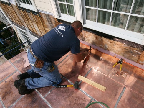 When we planned the roof’s layout, we designed the full-sized panels to stop about 6 inches short of the wall. We measured and bent the roof-to-wall pans on site, custom-fitting them to accountant for any variation in length when we joined the six rows together.