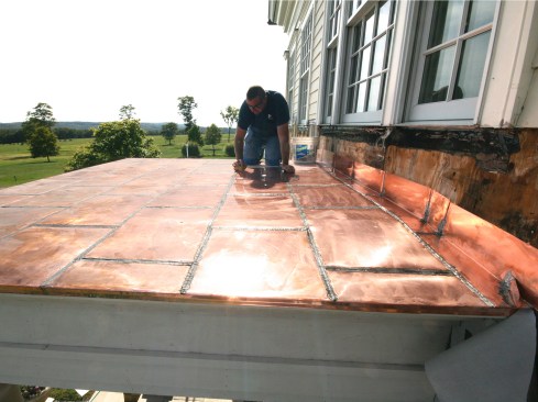 Before leaving the job, we wiped the roof surface down with baking soda and water a couple of times to help neutralize the acid from the soldering flux. The acid could cause the copper to prematurely (and unevenly) patina.