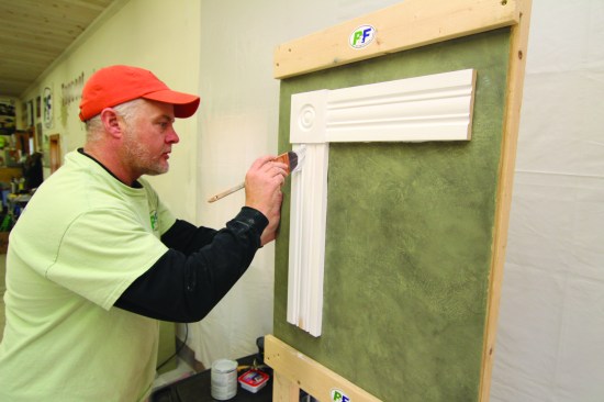 Finally, he paints the vertical trim pieces. If this had been a complete casing, he would have finished with the sill and apron.