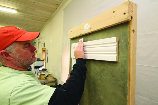 Applying primer raises the grain on a wood surface, so light sanding is always required before finish coats. The author scuffs over every surface with finegrit sand paper, taking care not to break through the painted
surface.