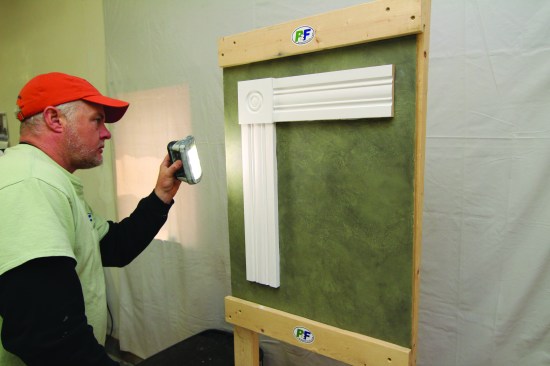 A small but powerful LED light helps him sight down all painted surfaces as he looks for areas that need to be sanded.