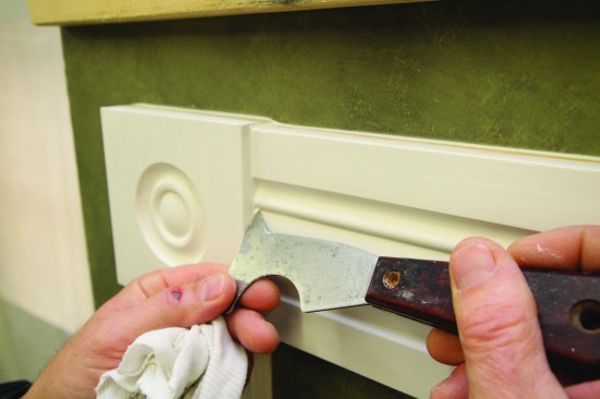 For tight and narrow areas such as the groove on this molding profile, the pointed end of the 5-in-1 tool works best for tooling the caulked joint.