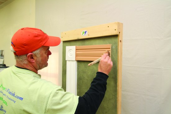 Working in the same deliberate sequence as before, the author applies the initial coat of finish paint. He begins each section by painting the edges and then finishes that section by carefully brushing the face. He starts with the head casing.