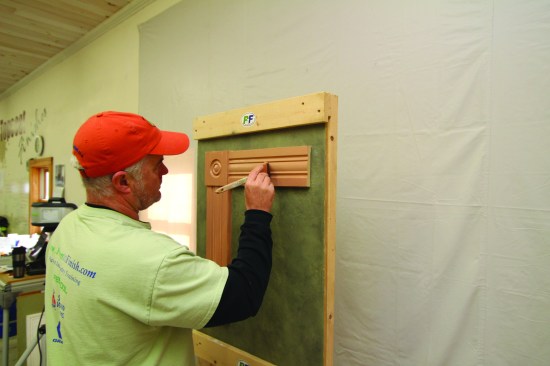 The object is to just dull the surface and to carefully avoid sanding through the layer of paint. He then brushes on the paint in the same sequence as before, starting with the head casing.