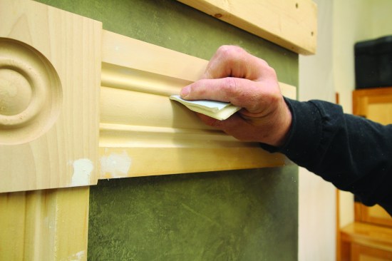 Folding sandpaper to a sharp crease can be effective for smoothing
out the narrow grooves of a trim profile.