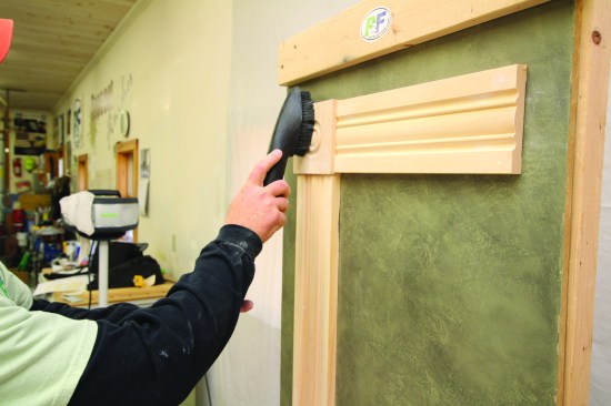 Even with a dust-collection system, a thorough cleaning is mandatory for a smooth paint job. The author first goes over the surface of the trim with a vacuum and soft brush.