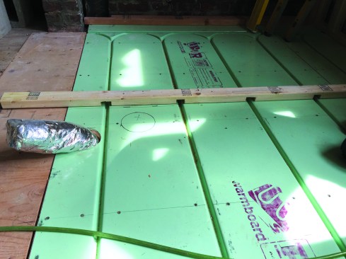 Rough-in locations were marked on the panel with a Sharpie, and interior wall plates were dadoed to allow fishing the PEX tubing in later, so tubing could be installed as late in the remodeling process as possible.