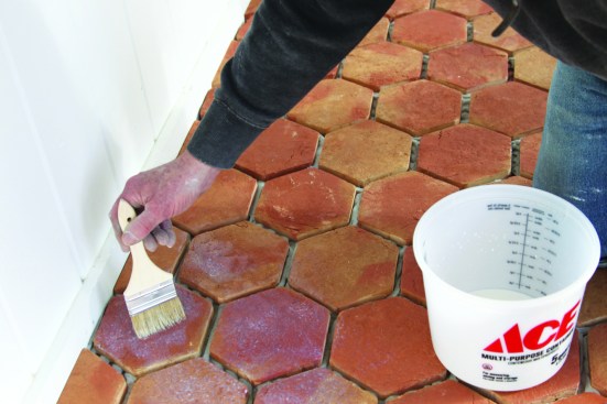 Even though the tile was presealed, the author applies waterbased sealant before grouting.